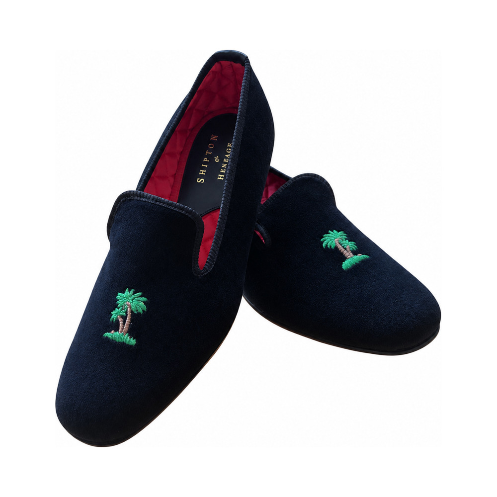 The Albert slipper in black velvet, two green palm trees embroidered on the vamp, red quilted lining.
