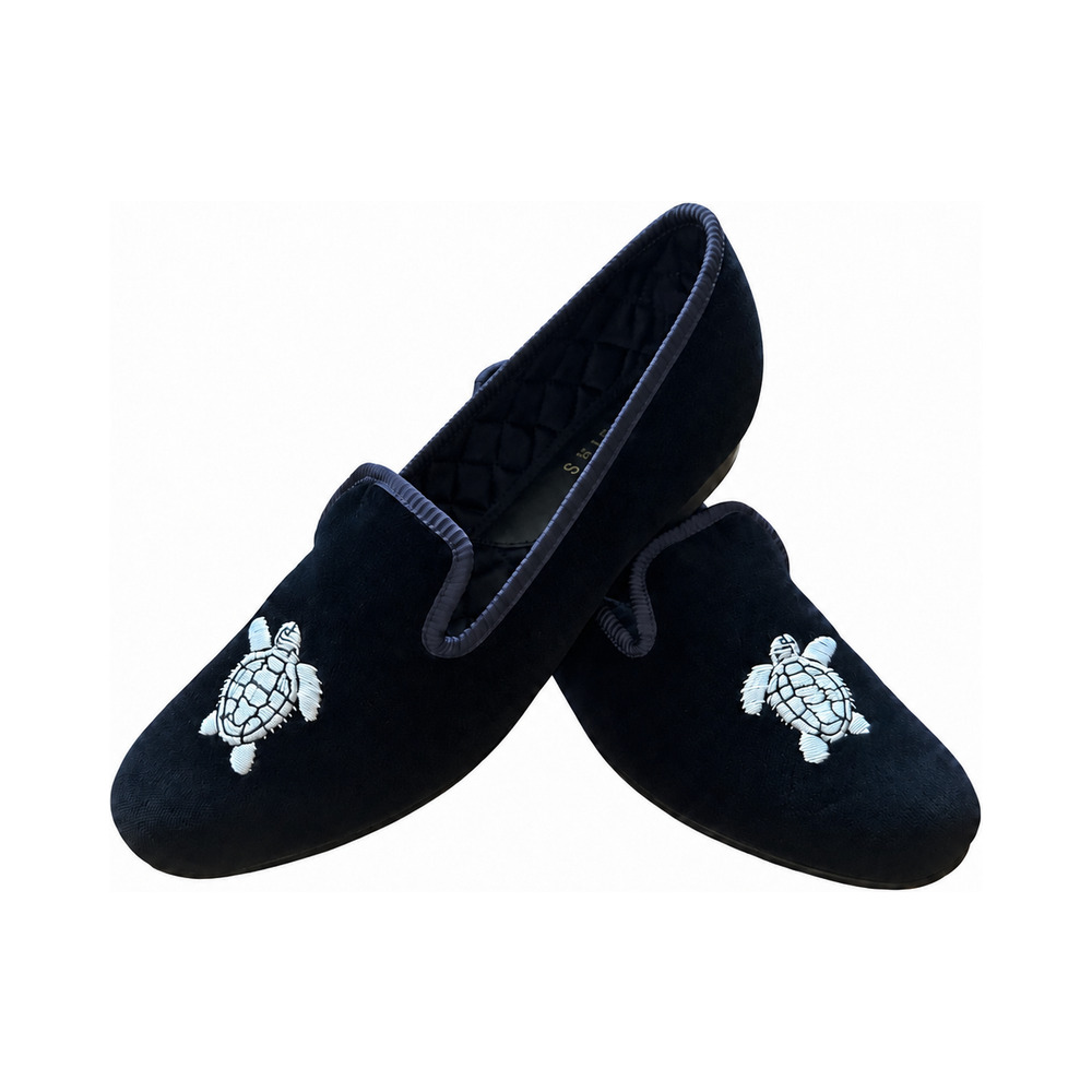 The Albert slipper in black velvet, a silver turtle embroidered on the vamp, black quilted lining.